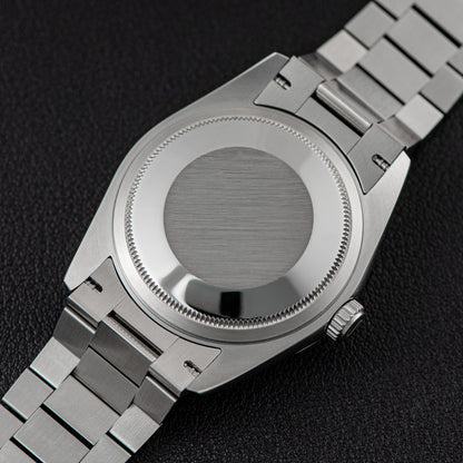 Back view of Sugess 449-DD36 S449.05 watch showing stainless steel case and band with folding clasp.